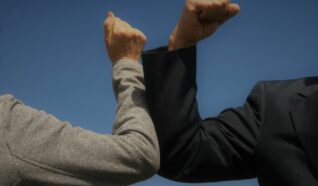 2 arms elbow bumping eachother