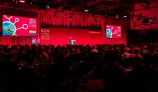 Photo of Emily speaking at the employee ownership association conference