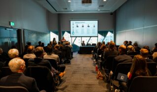 Photo of Emily speaking at the employee ownership association conference