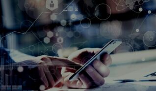 hands touching a smartphone sat at a desk with abstract images of lines and circles around it