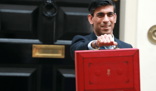 Rishi Sunak holding out a red briefcase in from of the houses of parliament