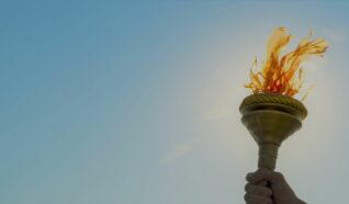 hand holding a paper tortch